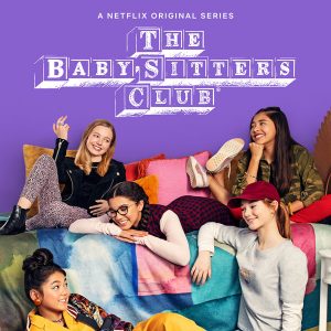 A promotional poster for Netflix’s The Baby-Sitters Club shows five diverse young girls lounging together on a colorful bedspread, smiling and posing playfully against a purple background.