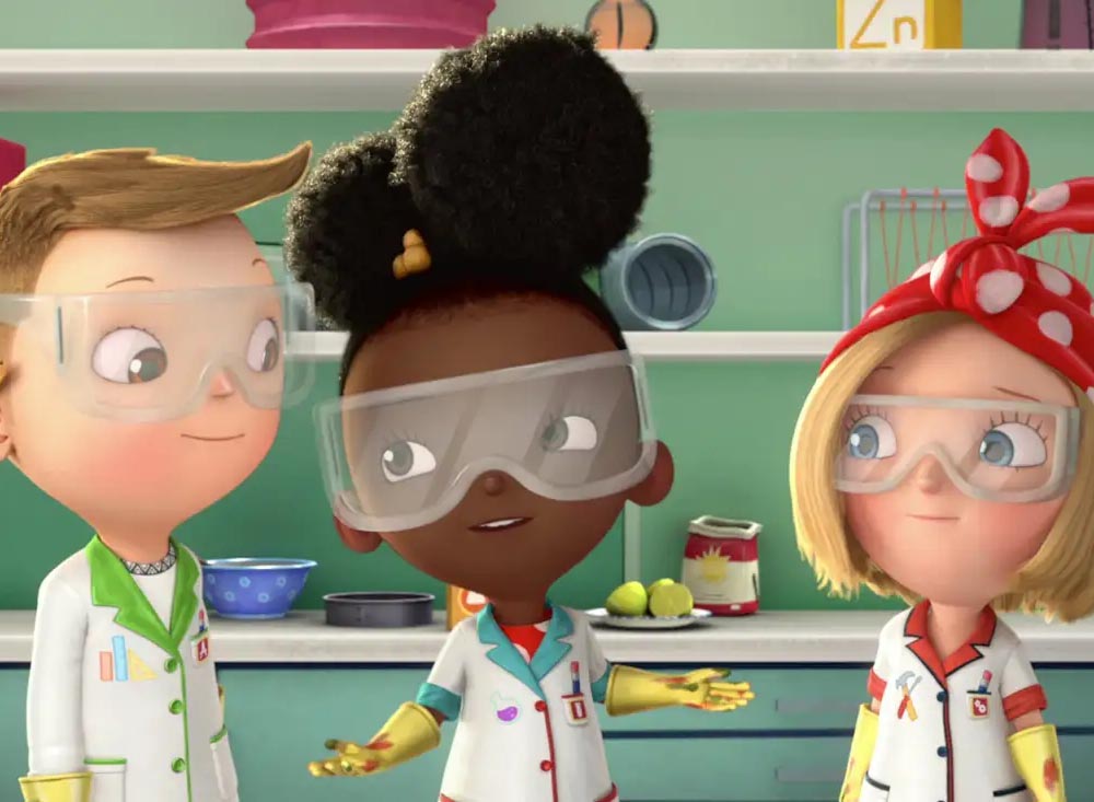 Three animated children from "Ada Twist, Scientist" wearing lab coats and safety goggles stand together in a laboratory setting, appearing engaged in a discussion. The child in the center, with dark skin and curly hair, gestures animatedly, while the other two, a blond child with a red polka-dot headband and a child with short light brown hair, listen attentively.