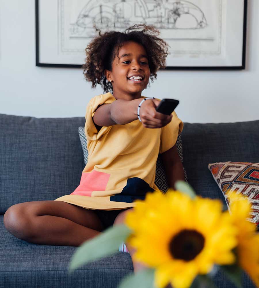 Young girl watching TV at home