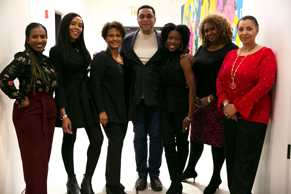 A group photo of the panelists from the event Tryin’ to Sleep in the Bed You Made in Brooklyn. The panel includes Virginia DeBerry, Donna Grant, Dr. Tyrha Lindsey-Warren, Yolonda Brinkley, Harry Lennix, and Tracey Kemble, all dressed in professional attire, standing together.