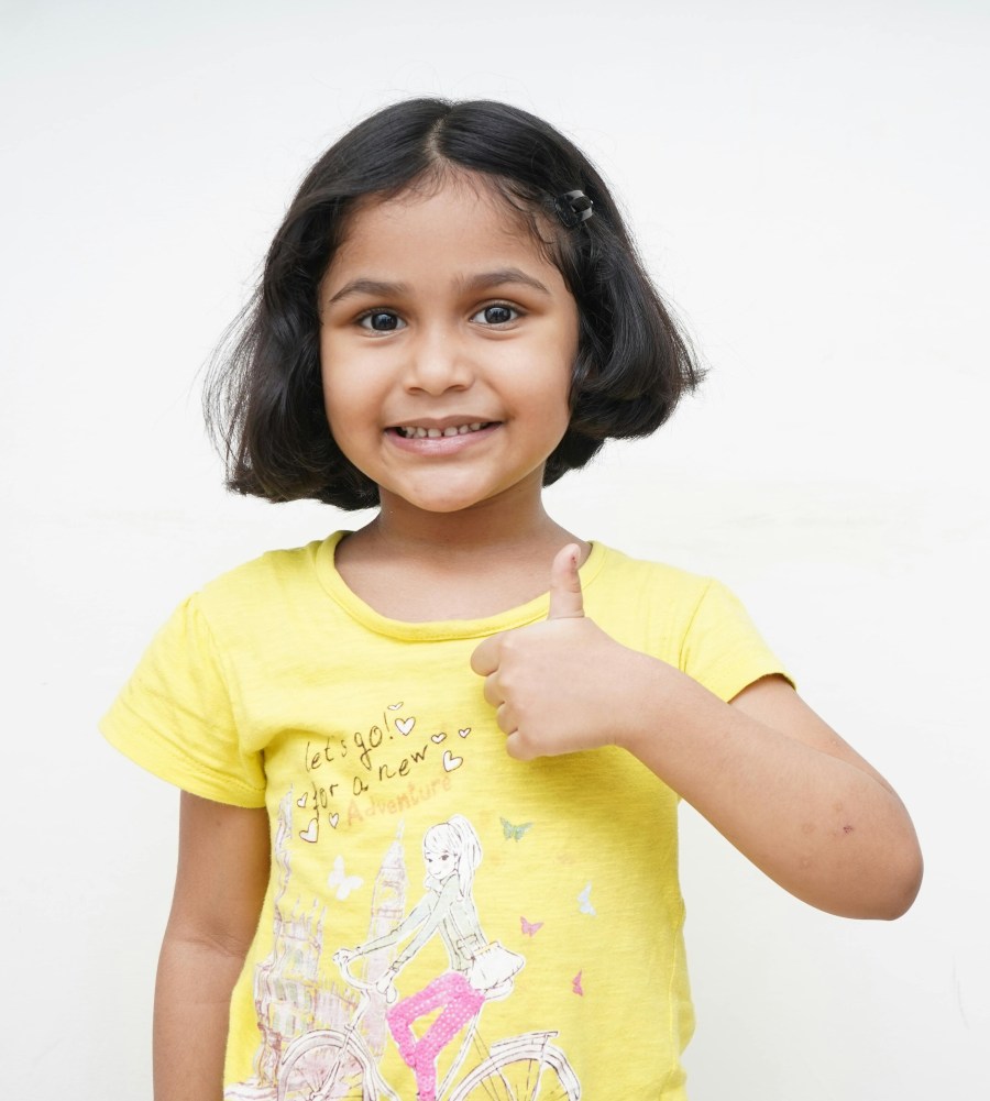 A Smiling Little Girl Doing a Thumbs up