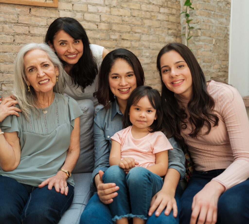 Group photo of multiple generations of Latina women smiling together